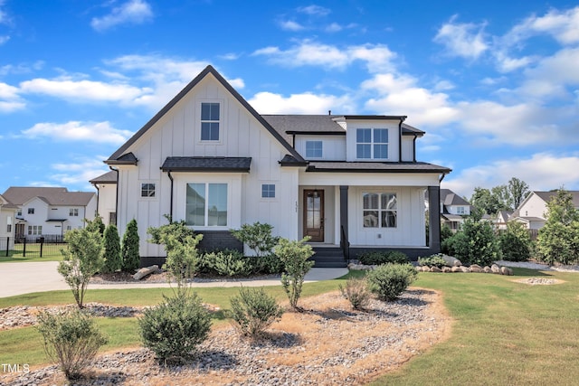 121 Nate Ct, Wake Forest, NC 27587 - modern farmhouse style home with board and batten siding, a front yard, a shingled roof, and a porch