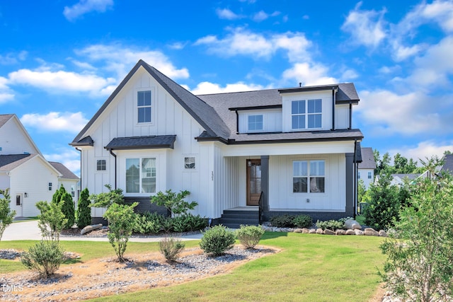 121 Nate Ct, Wake Forest, NC 27587 - modern farmhouse style home featuring board and batten siding, a front yard, a shingled roof, and a porch