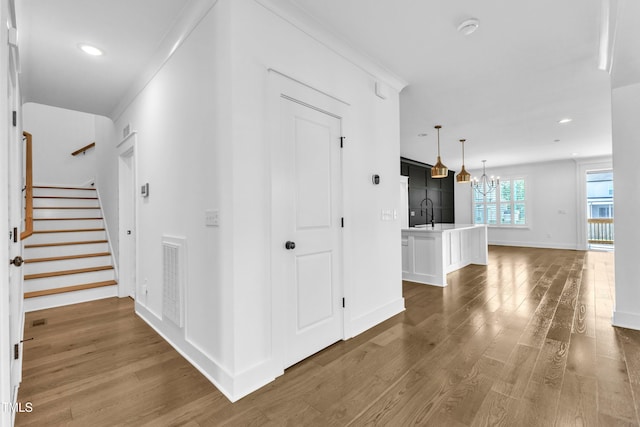 121 Nate Ct, Wake Forest, NC 27587 - corridor with a chandelier, wood finished floors, stairway, recessed lighting, and baseboards