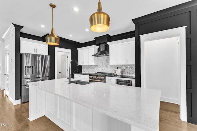121 Nate Ct, Wake Forest, NC 27587 - kitchen with stainless steel appliances, a sink, wall chimney exhaust hood, decorative backsplash, and light wood finished floors