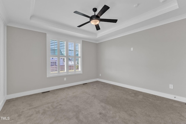 121 Nate Ct, Wake Forest, NC 27587 - unfurnished room with a raised ceiling, carpet, ornamental molding, a ceiling fan, and baseboards