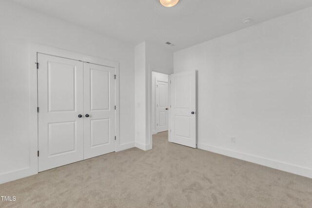 121 Nate Ct, Wake Forest, NC 27587 - unfurnished bedroom featuring carpet floors, a closet, and baseboards