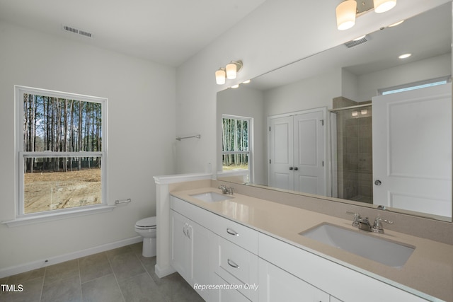 455 Beacon Hill Rd # 28, Lillington, NC 27546 - bathroom featuring healthy amount of natural light, a stall shower, double vanity, and toilet