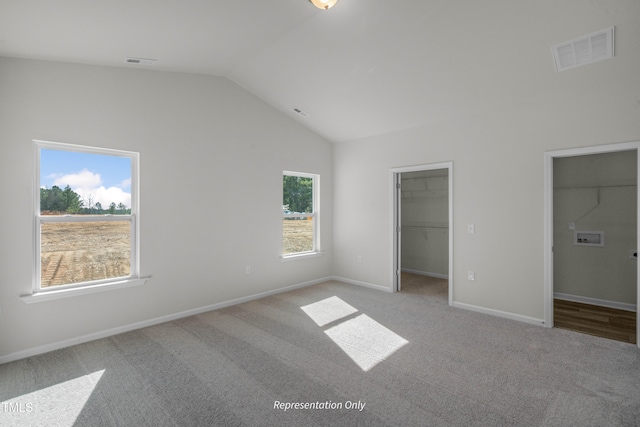 455 Beacon Hill Rd # 28, Lillington, NC 27546 - unfurnished bedroom with lofted ceiling, carpet flooring, a walk in closet, and baseboards