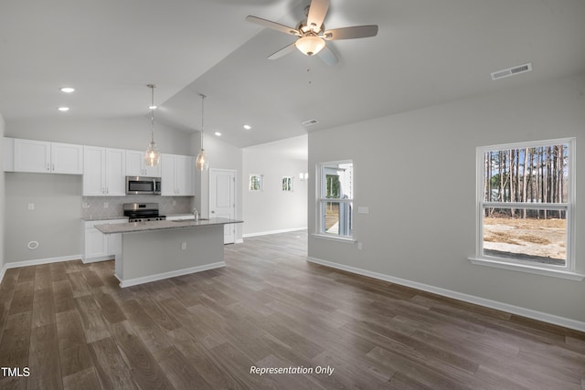 455 Beacon Hill Rd # 28, Lillington, NC 27546 - kitchen with stainless steel appliances, vaulted ceiling, white cabinets, open floor plan, and plenty of natural light