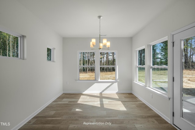 455 Beacon Hill Rd # 28, Lillington, NC 27546 - unfurnished dining area with a chandelier, wood finished floors, and baseboards
