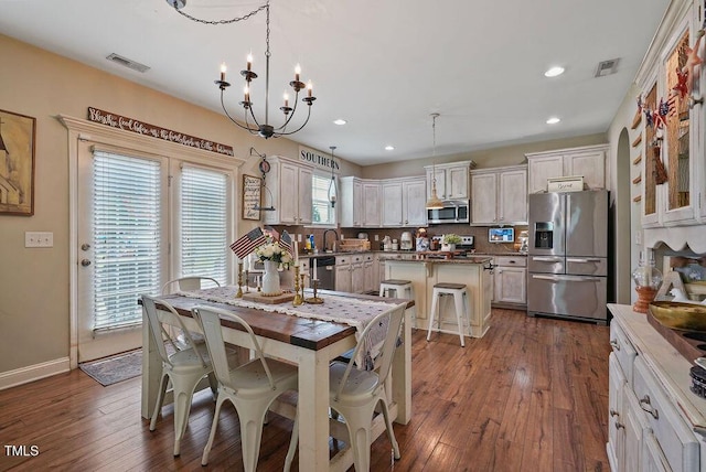 15 Scuppernong Ln, Lillington, NC 27546 - dining space featuring recessed lighting, dark wood finished floors, a chandelier, and baseboards