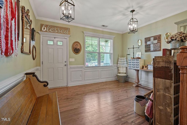 15 Scuppernong Ln, Lillington, NC 27546 - foyer entrance with a chandelier, wood finished floors, wainscoting, and crown molding