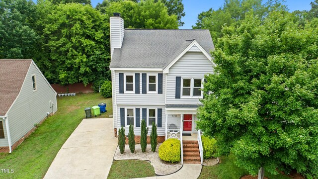 3405 E Jameson Rd, Raleigh, NC 27604 - view of front of home featuring a front yard, a chimney, a shingled roof, and covered porch