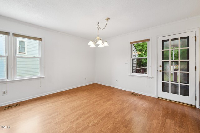 3405 E Jameson Rd, Raleigh, NC 27604 - empty room featuring a chandelier, ornamental molding, light wood-style flooring, and baseboards