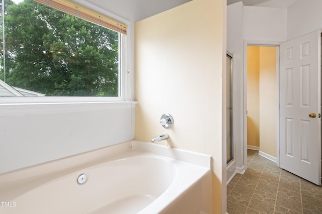 3405 E Jameson Rd, Raleigh, NC 27604 - full bathroom featuring a garden tub, a stall shower, and baseboards