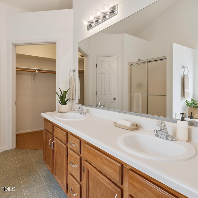 3405 E Jameson Rd, Raleigh, NC 27604 - full bathroom featuring double vanity, a stall shower, a walk in closet, and tile patterned flooring