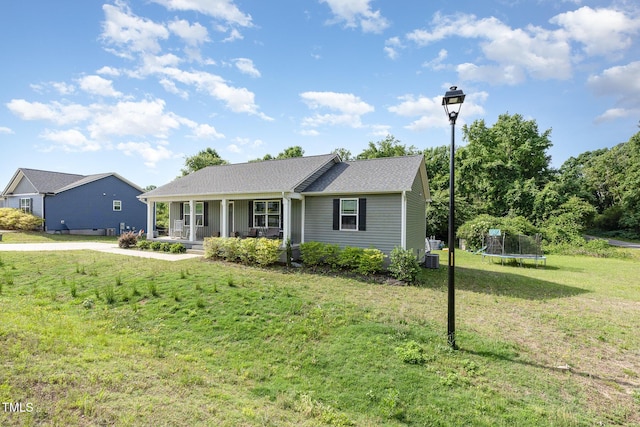 18 Hunter Fox Trl, Angier, NC 27501 - ranch-style house featuring a trampoline, covered porch, and a front lawn