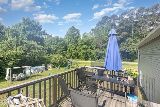 18 Hunter Fox Trl, Angier, NC 27501 - deck featuring a playground, a lawn, and an outdoor pool