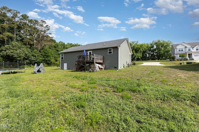 18 Hunter Fox Trl, Angier, NC 27501 - back of house featuring a trampoline, a deck, and a yard