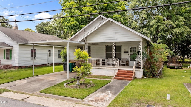517 E 14th St, Lumberton, NC 28358 - view of front of home with covered porch, concrete driveway, a front lawn, and an attached carport