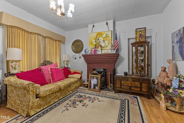 517 E 14th St, Lumberton, NC 28358 - living room with wood finished floors, a chandelier, a brick fireplace, and crown molding