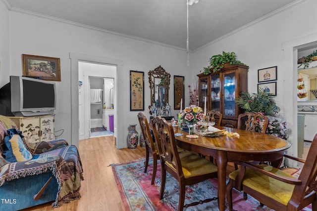 517 E 14th St, Lumberton, NC 28358 - dining area featuring light wood-style floors, ornamental molding, and baseboards
