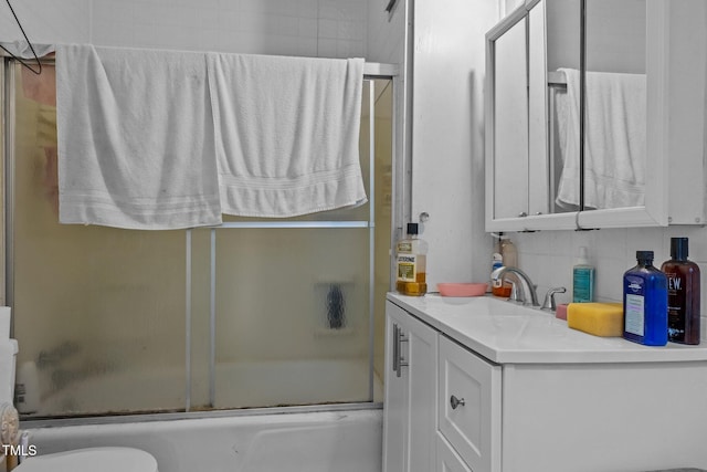 517 E 14th St, Lumberton, NC 28358 - bathroom featuring vanity, enclosed tub / shower combo, decorative backsplash, and toilet