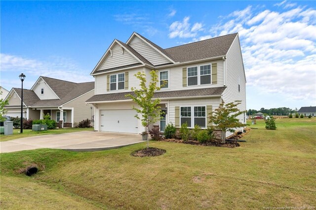 40 Arlie Ln, Lillington, NC 27546 - view of front of house with a garage, concrete driveway, and a front lawn