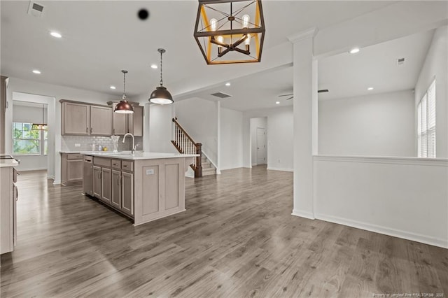 40 Arlie Ln, Lillington, NC 27546 - kitchen with open floor plan, a sink, light countertops, decorative backsplash, and a kitchen island with sink