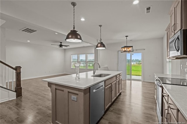 40 Arlie Ln, Lillington, NC 27546 - kitchen featuring appliances with stainless steel finishes, a sink, plenty of natural light, dark wood-style flooring, and recessed lighting