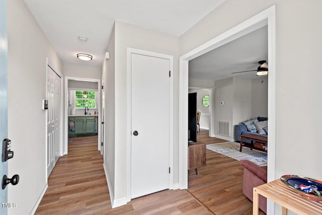 411 Buxton St, Durham, NC 27713 - hallway featuring light wood-style floors and a sink