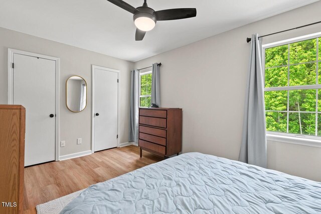 411 Buxton St, Durham, NC 27713 - bedroom featuring wood finished floors, ceiling fan, and two closets
