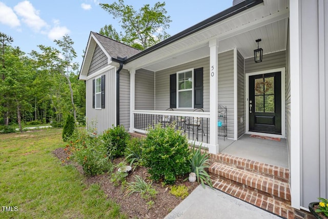50 Harriet Gentry Ln, Timberlake, NC 27583 - doorway to property with covered porch and a lawn
