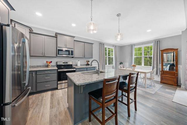 50 Harriet Gentry Ln, Timberlake, NC 27583 - kitchen with stainless steel appliances, a sink, gray cabinetry, a kitchen breakfast bar, and ornamental molding
