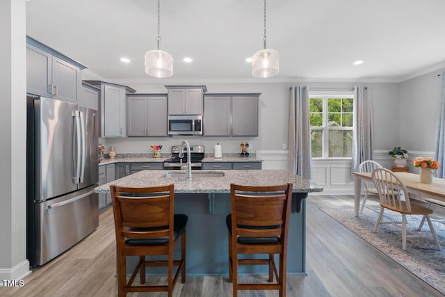 50 Harriet Gentry Ln, Timberlake, NC 27583 - kitchen featuring appliances with stainless steel finishes, gray cabinets, a sink, crown molding, and a center island with sink