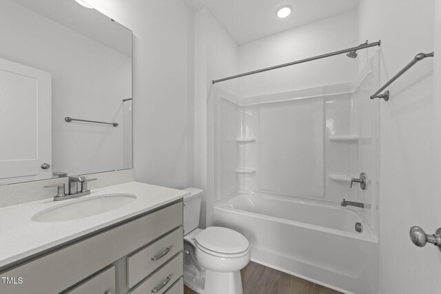 447 N Fisher St, Raleigh, NC 27610 - bathroom with vanity, toilet, bathtub / shower combination, and wood finished floors
