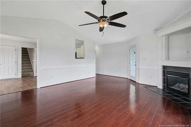 120 Wood Valley Ln, Raeford, NC 29376 - unfurnished living room with a ceiling fan, wood finished floors, lofted ceiling, a tiled fireplace, and stairs