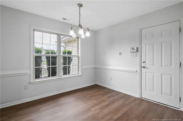 120 Wood Valley Ln, Raeford, NC 29376 - unfurnished dining area with a chandelier, dark wood-style flooring, and baseboards