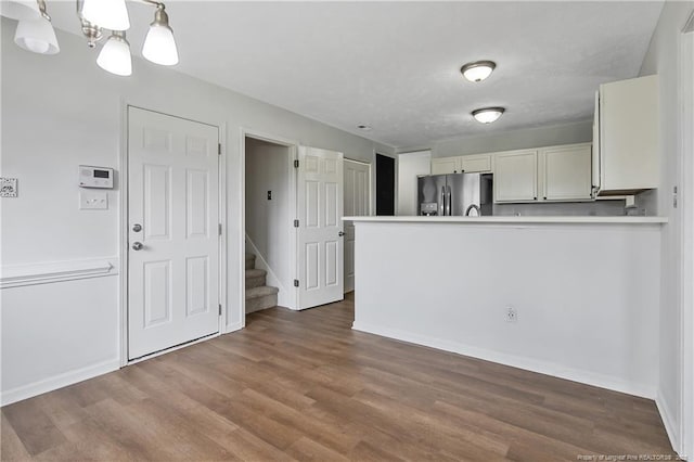120 Wood Valley Ln, Raeford, NC 29376 - kitchen with stainless steel fridge with ice dispenser, a peninsula, wood finished floors, light countertops, and baseboards