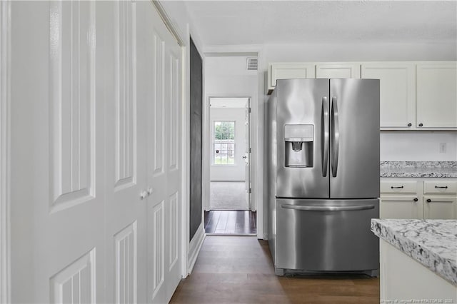 120 Wood Valley Ln, Raeford, NC 29376 - kitchen featuring stainless steel fridge, dark wood-style flooring, white cabinets, and light stone countertops