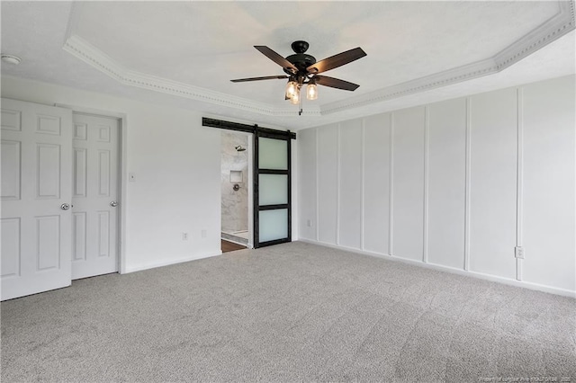 120 Wood Valley Ln, Raeford, NC 29376 - unfurnished bedroom featuring a barn door, a raised ceiling, carpet floors, crown molding, and ceiling fan