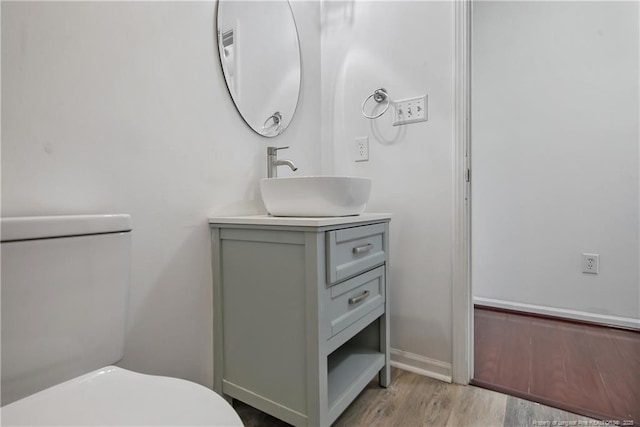 120 Wood Valley Ln, Raeford, NC 29376 - bathroom featuring vanity, toilet, wood finished floors, and baseboards