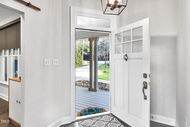 390 Lake Magnolia Way, Smithfield, NC 27577 - entryway with baseboards, a chandelier, and wood finished floors