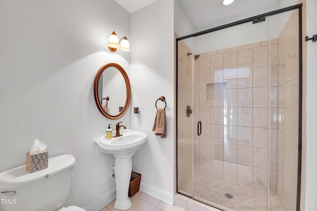 390 Lake Magnolia Way, Smithfield, NC 27577 - bathroom featuring toilet, a stall shower, tile patterned flooring, and baseboards