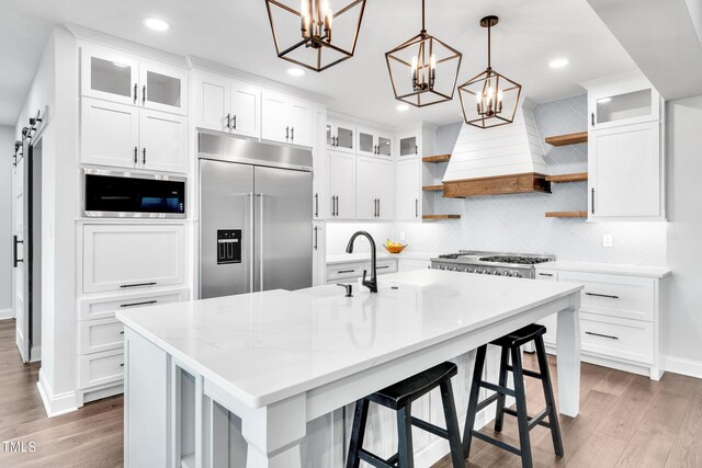 390 Lake Magnolia Way, Smithfield, NC 27577 - kitchen with built in appliances, open shelves, a chandelier, light wood-style flooring, and recessed lighting