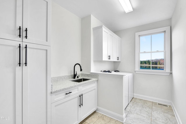 390 Lake Magnolia Way, Smithfield, NC 27577 - washroom featuring cabinet space, washer and clothes dryer, and baseboards