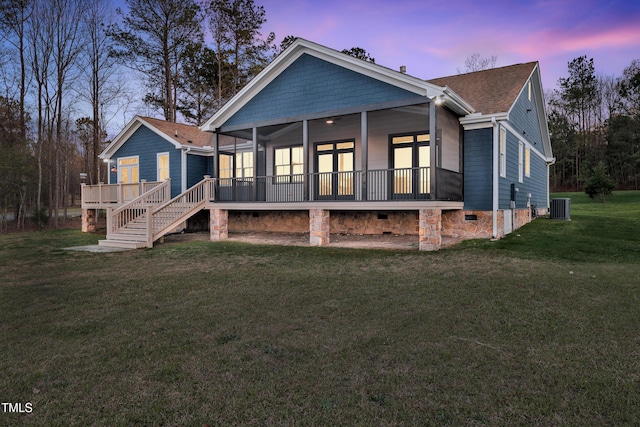 390 Lake Magnolia Way, Smithfield, NC 27577 - back of property at dusk featuring central AC unit, a sunroom, crawl space, a lawn, and roof with shingles
