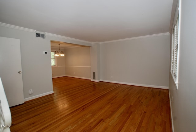 1908 Smallwood Dr, Raleigh, NC 27605 - spare room with a chandelier, baseboards, crown molding, and wood finished floors
