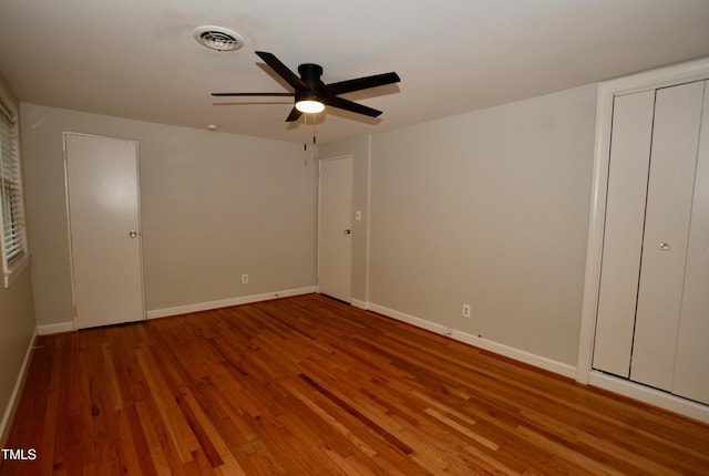 1908 Smallwood Dr, Raleigh, NC 27605 - unfurnished bedroom featuring wood finished floors, baseboards, and ceiling fan