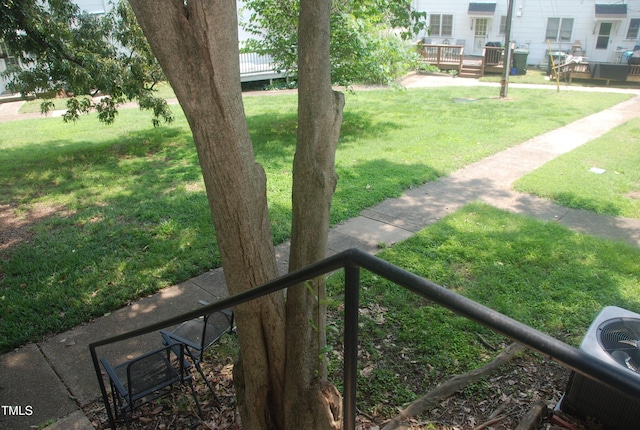 1908 Smallwood Dr, Raleigh, NC 27605 - view of green lawn featuring a wooden deck and cooling unit