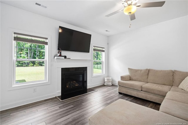 25 Vast View Way, Youngsville, NC 27596 - living room with wood finished floors, baseboards, a ceiling fan, and a glass covered fireplace