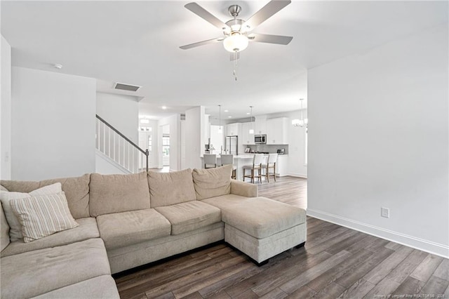 25 Vast View Way, Youngsville, NC 27596 - living area featuring dark wood-style floors, stairway, a ceiling fan, baseboards, and a chandelier