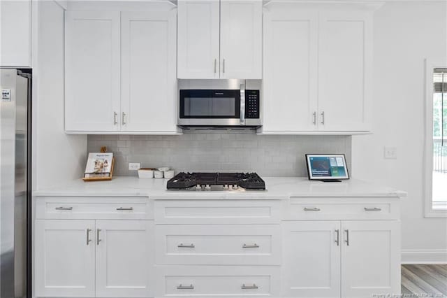 25 Vast View Way, Youngsville, NC 27596 - kitchen featuring appliances with stainless steel finishes, white cabinets, backsplash, and baseboards