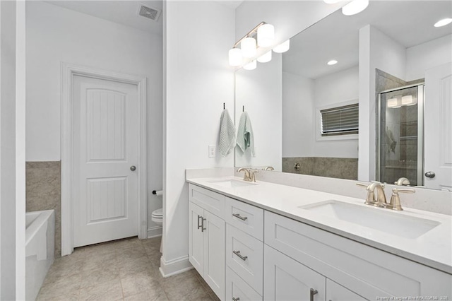 25 Vast View Way, Youngsville, NC 27596 - bathroom with double vanity, a stall shower, a garden tub, toilet, and tile patterned flooring